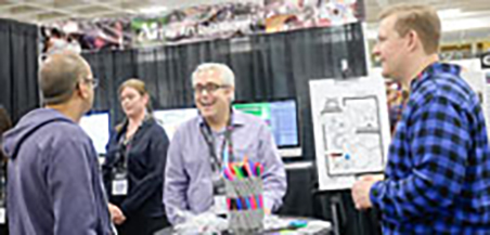 A fair booth being operated by an older gentleman.